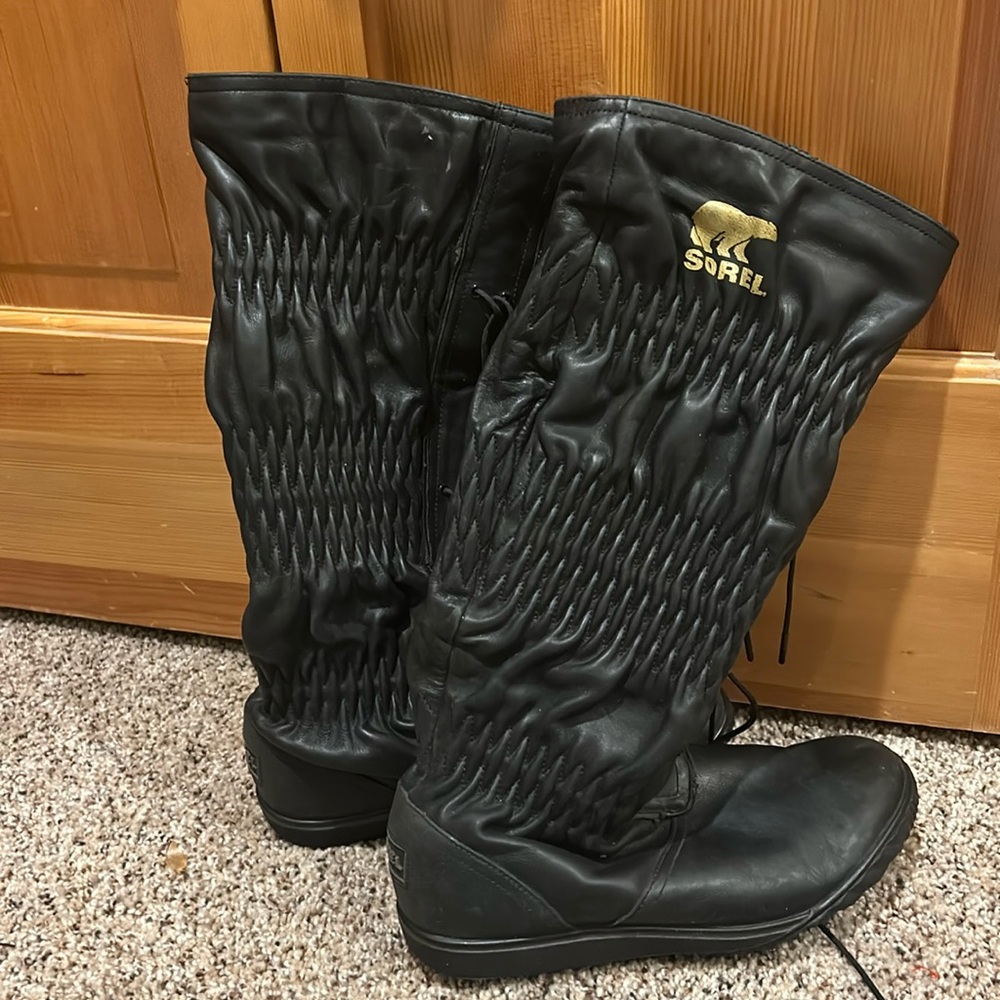Sorel tall black boots with gathered ties and runching up boot